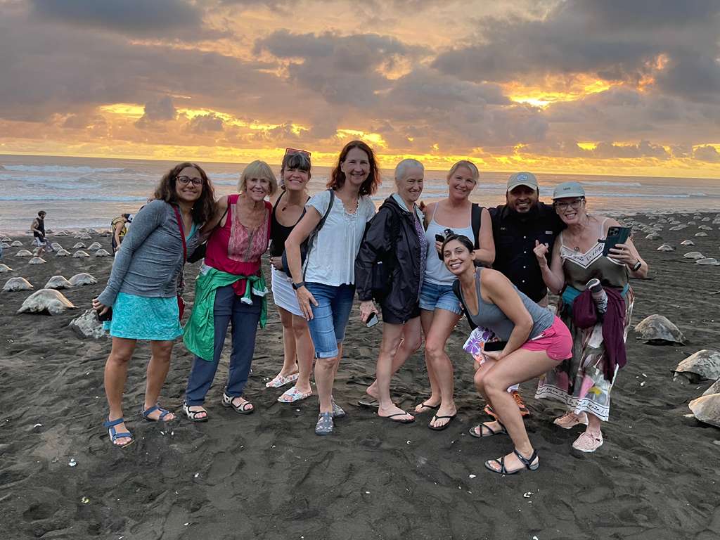 Group enjoying Nosara group transportation during a visit to Ostional turtle beach at sunset